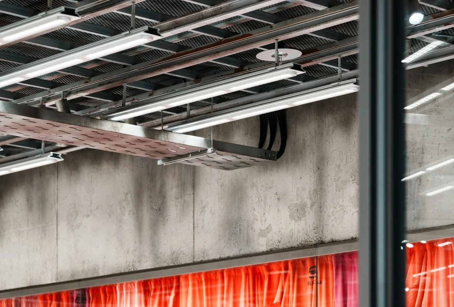Industrial ceiling with lights and concrete wall