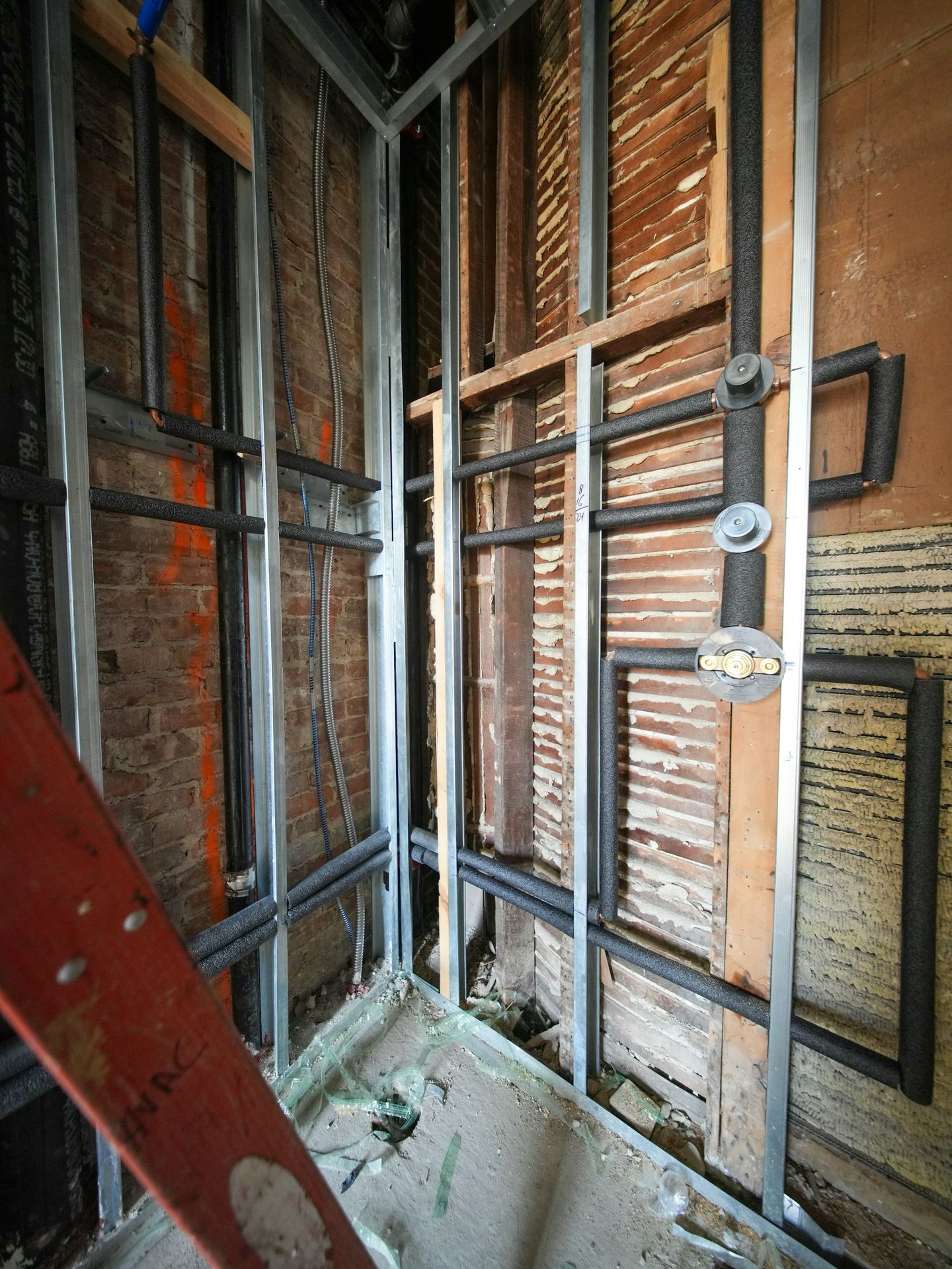 Plumbing pipes installed in a wall during renovation.